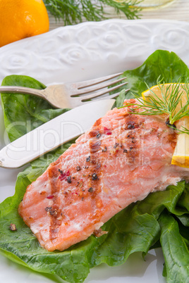 grilled salmon fillets on spinach