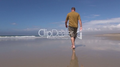 man walking at beach