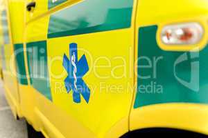 Paramedic symbol on yellow ambulance car
