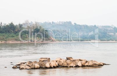 Peaceful scenic view of rocks middle the river