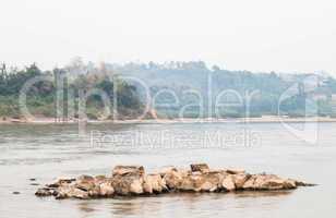 Peaceful scenic view of rocks middle the river