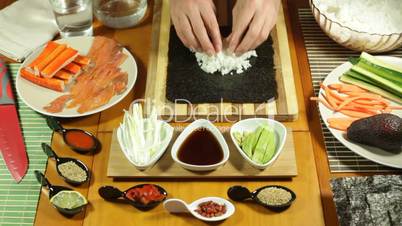 Putting Sushi rice on seaweed