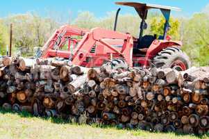 Stack of firewood and tractor