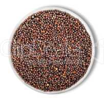 Black mustard seeds in plate isolated