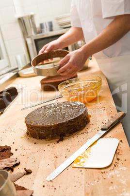 Cook taking out cake from cake form