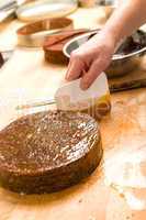 Male chef decorating chocolate cake in kitchen