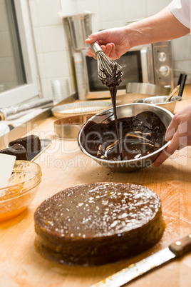 Cook kitchen dripping chocolate sauce for cake