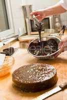 Cook kitchen dripping chocolate sauce for cake