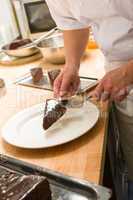Chef placing slice of chocolate cake
