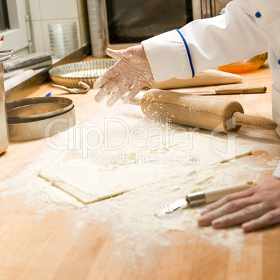 Chef pouring flour dough and rolling pin