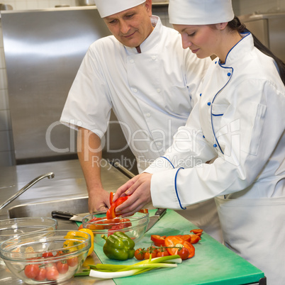 Cooks preparing salad in restaurant's kitchen