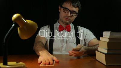 Funny nerd man counting money at night