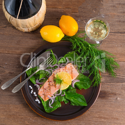 grilled salmon fillets on spinach