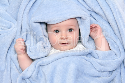 beautiful baby after bath under a blanket