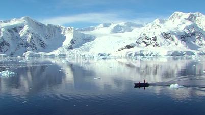 small boat in antarctic ocean