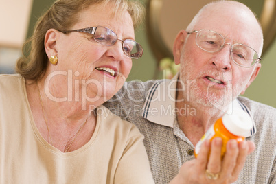 Senior Couple Reading Medicine Bottle