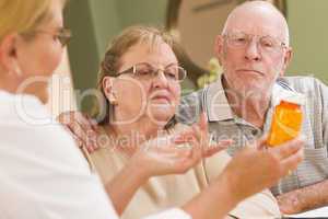 Doctor or Nurse Explaining Prescription Medicine to Senior Coupl