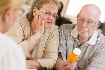 Doctor or Nurse Explaining Prescription Medicine to Senior Coupl