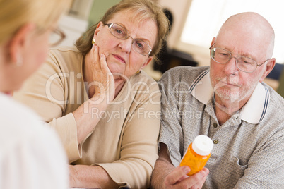 Doctor or Nurse Explaining Prescription Medicine to Senior Coupl