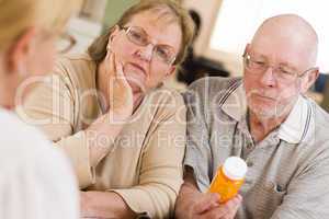 Doctor or Nurse Explaining Prescription Medicine to Senior Coupl