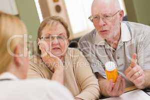 Doctor or Nurse Explaining Prescription Medicine to Senior Coupl