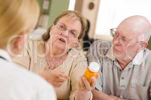 Doctor or Nurse Explaining Prescription Medicine to Senior Coupl