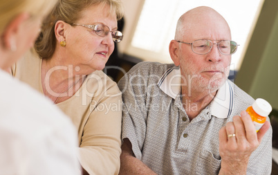 Doctor or Nurse Explaining Prescription Medicine to Senior Coupl