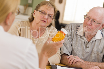 Doctor or Nurse Explaining Prescription Medicine to Senior Coupl