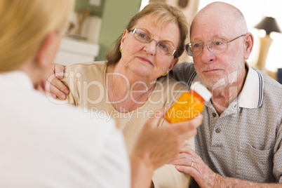 Doctor or Nurse Explaining Prescription Medicine to Senior Coupl