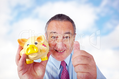Man with piggy bank holding thumbs up