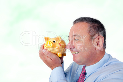 Businessman is pleased with his piggy bank