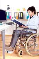 Sitting in a wheelchair working at desk