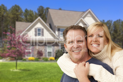 Happy Couple Hugging in Front of House