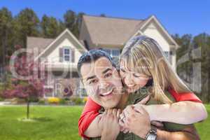 Mixed Race Couple Hugging in Front of House