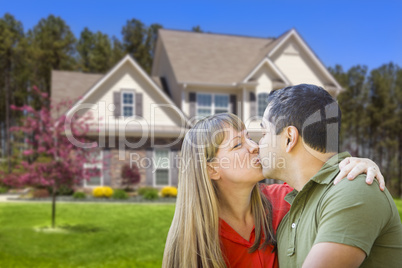 Mixed Race Couple Hugging in Front of House