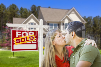 Couple in Front of Real Estate Sign and House