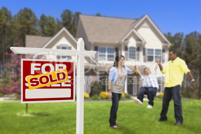 Hispanic Family in Front of Sold Real Estate Sign, House