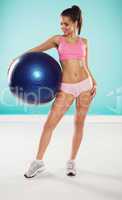 woman posing with a pilates ball