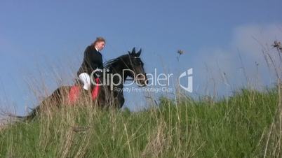 Girl riding a horse in the steppe