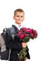 Schoolboy is holding flowers. Back to school