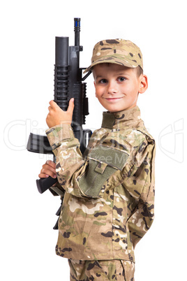 Young boy dressed like a soldier with rifle