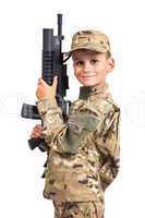 Young boy dressed like a soldier with rifle