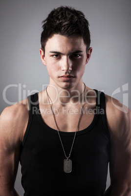 Muscular built man with a dog tags.