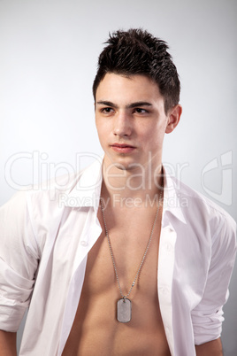 Healthy muscular young man on grey background