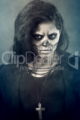 Young woman in day of the dead mask skull. Halloween face art