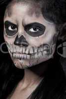 Young woman in day of the dead mask skull. Halloween face art