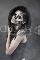 Young woman in day of the dead mask skull. Halloween face art