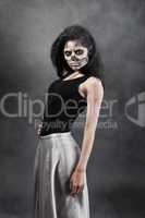 Young woman in day of the dead mask skull. Halloween face art