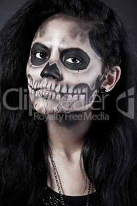 Young woman in day of the dead mask skull. Halloween face art