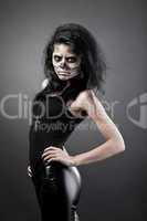 Young woman in day of the dead mask skull. Halloween face art